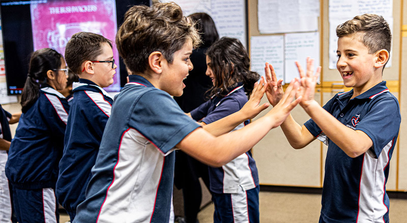 Children clapping hands at Mother Teresa Catholic Primary School Westmead